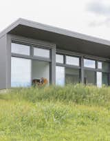 The rear exposures are composed of  Photo 9 of 16 in Budget Breakdown: The Foundation Is Also the Floor at This Shedlike $1.1M Hudson Valley Retreat