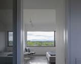 A second bedroom overlooks the Catskills mountains and is meant to double as a workshop.  Photo 5 of 16 in Budget Breakdown: The Foundation Is Also the Floor at This Shedlike $1.1M Hudson Valley Retreat