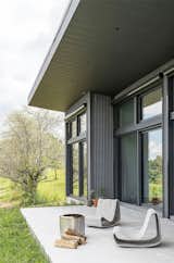 The outdoor seating was specially designed by IDSR Architecture.  Photo 15 of 16 in Budget Breakdown: The Foundation Is Also the Floor at This Shedlike $1.1M Hudson Valley Retreat