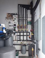 The heating-and-cooling system uses a heat pump to flow hot and cold water through pipes embedded in the polished concrete radiant floors.