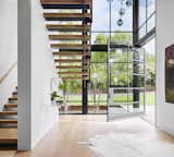 Entry, large 8'x10' off-center steel pivot door, minimal stair detailing