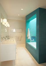 The children’s bathroom had no direct window to the outside. So the shower/bath was conceived as a massive inhabitable lightwell, with two colors of mosaic glass tile for the outside and inside.  It was designed with the client’s eight year old daughter, and the metaphor of a geode was embraced.