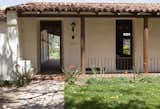 The design of Dutton Architects reinforced the idea of simple rooms built around an open courtyard, linked by a deep roof overhang for shade. The idea is basically an interpretation of a traditional Spanish courtyard house or hacienda.

 In this image, one can see that the front door leads to a covered vestibule that is open to the air and views.