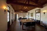 The original living room featured tall heavy timber trusses, wood ceilings and floors, a  massive fireplace, and french doors with decorative iron screens. Dutton Architects sandblasted the ceiling and trusses, rebuilt the fireplace, restored the adobe walls, replaced the doors and windows, and installed a new floor with radiant heat.