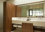 View of the custom walnut and limestone vanity.