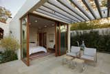 The guest house opens up to a covered terrace through full-height ‘lift and slide’ doors. The Santa Barbara stone of the pool deck continues in as the floor of the guest house.