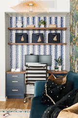 A former closet in the main living space was demoed to create the perfect nook for a functional home office. The built in includes cabinets painted in Clare paint's Good Night Mood, Schoolhouse Electric hardware, and walnut desktop and floating shelves. The walls of the nook are covered in Exotic Fruit wallpaper which elegantly tie into the jungalow themed print on the back wall. 
