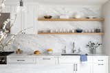 Marble backsplash with white shaker cabinets.