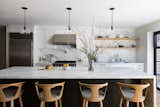 Marble island and backsplash in modern kitchen.