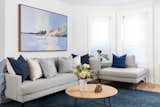Sophisticated den with indigo accents and bay windows.