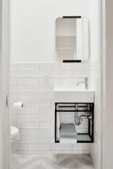 Half bath with chevron flooring.