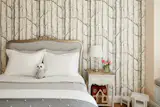 Whimsical wallpaper in a girls bedroom.