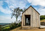 Exterior, Cabin Building Type, Wood Siding Material, Shed RoofLine, and Metal Roof Material Front with vertical green oak, rainscreen cladding  Photo 1 of 7 in The Woodcutter's Refuge by Life Space Cabins