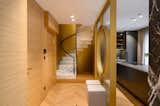 A powerful circular staircase, cocooned inside the brass-coloured covering, is a strong as well as sculptural feature of the room, giving it a soft finishing appeal.​​​​​​​​