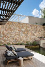 Outdoor, Large Patio, Porch, Deck, Side Yard, Small Pools, Tubs, Shower, Trees, Wood Patio, Porch, Deck, Shrubs, Decking Patio, Porch, Deck, Flowers, Stone Fences, Wall, and Swimming Pools, Tubs, Shower Pool Courtyard  Photo 10 of 34 in 68 Jonkershoek - nature , water, and material textures feature in this South African home by Mieke Vermaak