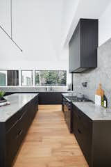 Kitchen, Engineered Quartz Counter, Laminate Cabinet, Range, Pendant Lighting, Medium Hardwood Floor, and Undermount Sink Hilltop Farm Kitchen  Photo 7 of 20 in Hilltop Farm by Hygge Design+Build