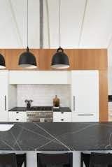 Kitchen, Pendant Lighting, Refrigerator, Range, Undermount Sink, White Cabinet, Granite Counter, Light Hardwood Floor, and Ceramic Tile Backsplashe Kitchen  Photo 14 of 36 in The Slate House by Hygge Design+Build