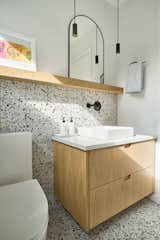 Ceramic Tile Backsplashe, Engineered Quartz Counter, Wood Cabinet, Ceramic Tile Floor, Undermount Sink, and Pendant Lighting Half Bath AFTER  Photo 12 of 19 in Forest Hills Reno by Hygge Design+Build
