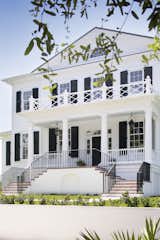 Front of Old Grove estate featuring double grand staircase, gas lanterns, crisp Essex green shutters.