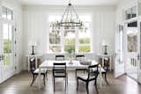 In kitchen dining area overlooking Spanish moss. To the right is a screened-in porch with green Timberlane shutters and to the left is a grand, open air back porch overlooking the Florida waterfront.