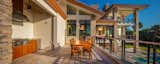 Outdoor kitchen and bar area overlooking the pool and water