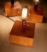 Reclaimed Vertical Grain Fir Lamp.  Simplicity and sophistication in one light. 

These large solid wood light bases are produced by using beautifully preserved, reclaimed Douglas Fir, engineered for end grain patterning that’s unique to old growth wood.

The golden coppery hue of Fir when oiled brings a warmth to any room, even when the light is not on. This simple piece can enhance any room, and when switched on the Edison bulb provides a warm rich glow creating a relaxing ambiance. 

This light was created so the socket sits just above the base, so that the bulb and wood grain are its highlighted features. 

To purchase:
https://toddalanwoodcraft.com/collections/lighting/products/reclaimed-vertical-grain-fir-lamp

Since wood is an organic product, no two light bases will look exactly the same.  