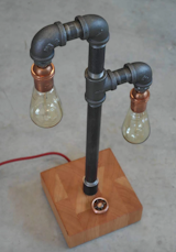 Reclaimed Old Growth Vertical Grain Fir Steel and Copper Lamp.

This vintage style industrial lighting fixture is the perfect size for a loft or would look great in a family room as it doesn't take up too much space and can be the right fit. This Todd Alan Woodcraft built light is a great conversation piece and adds a focal point to your modern or urban décor.

To purchase:
https://toddalanwoodcraft.com/collections/lighting/products/vg-reclaimed-old-growth-fir-steel-and-copper-lamp

The light features a beautiful base of reclaimed old growth Fir, showcasing unique and funky end grain ring patterns. The base’s lines tie in beautifully with the filaments of the 60 watt Edison bulbs, the steel of the piping, and copper round dimmer dial and sockets.
