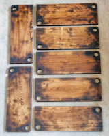 French Oak Blackened Hand Hole Boards 
(pictured is 22” x 8” x 1”  Double hand hole)

These boards are cut from a single piece of natural French Oak and is hand roasted by an artisan woodcrafter. Once blackened the board is brushed, oiled with Walrus Oil’s Cutting Board Oil and waxed with Walrus Oil’s food grade finish wax to enhance its natural grain and protect its distinctive look. 

Due to the nature of the product, grain pattern, color and shape may slightly differ from the product pictured.
 
Each board has a unique characteristic in grain and are so beautiful you will want keep it on your table top, or hang it on your wall as a piece of functional art!

To purchase:
https://toddalanwoodcraft.com/collections/serving-boards/products/french-oak-blackened-hand-hole-boards
 
The boards come in 4 sizes, the largest size having two holes placed diagonally across the board for easy carrying of larger items. Due to the nature of natural edge, there may be a very negligible size difference in width and length. Make sure you select the size you’d like from the choices in the drop down menu.
 
10” x 5-1/4” x 1”
12” x 8” x 1”
16” x 8” x 1”
22” x 8” x 1”  (Double hand hole)