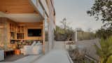 Sliding glass doors blur the boundaries between the interior and the exterior, allowing residents to harmoniously commune with nature