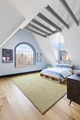 Bedroom, Bed, Night Stands, Ceiling Lighting, Dresser, and Light Hardwood Floor After: Top floor bedroom with vaulted ceilings   Photo 1 of 14 in Jackson Heights Transormation by Ward 5 Design