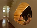 A uniquely shaped, well-lit nook under the stairs of the Peas in a Pod residence provides an imaginative space for play. CplusC Architectural Workshop designed much of the space around the clients four children's needs.
