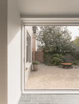 The garden room is finished in clay pavers whose gray hues evoke the kitchen cooking island's Cumbrian slate surface.