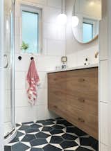 The new walnut vanity cabinet provides much needed storage for towels and toiletries.