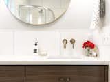 More surface area on the counter for toiletries with a wall mounted faucet.