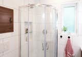 The curved corner shower offers maximum space efficiency.
