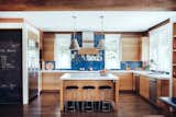 Kitchen, Ceiling Lighting, Ceramic Tile Backsplashe, Wall Oven, Marble Counter, Medium Hardwood Floor, Refrigerator, Dishwasher, Drop In Sink, and Wood Cabinet  Photo 4 of 7 in Gracefully Green by Fergus Garber Architects