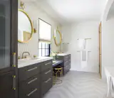 Master bathroom with large 6 over 6 double hung window, two symmetrical sinks on both sides.