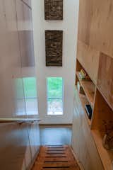 A fir beam stairway leads to the second floor. Open shelving provides additional storage.
