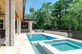 Outdoor, Back Yard, Landscape Lighting, Large Patio, Porch, Deck, Large Pools, Tubs, Shower, and Stone Patio, Porch, Deck Rear Exterior Pool and Spa  Photo 5 of 19 in The Bridges House by Virginia Pizzi