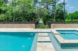 Outdoor, Metal Fences, Wall, Stone Patio, Porch, Deck, Back Yard, Walkways, Trees, Swimming Pools, Tubs, Shower, Large Pools, Tubs, Shower, and Landscape Lighting Golf Cart Bridge and Line of Sight  Photo 6 of 19 in The Bridges House by Virginia Pizzi