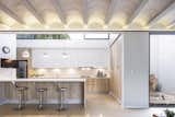 Kitchen, Ceiling, Cooktops, White, Concrete, Refrigerator, Undermount, Pendant, Engineered Quartz, and Accent  Kitchen Cooktops Engineered Quartz White Pendant Accent Ceiling Photos from PDC House