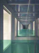 At night, warm light from the interior shines through the curtain walls and glass handrails, creating stunning light and shade