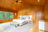 Spacious master suite with panoramic view of the lake.