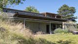 Exterior, Green Siding Material, House Building Type, A-Frame RoofLine, Stucco Siding Material, Green Roof Material, Wood Siding Material, Metal Roof Material, Flat RoofLine, and Metal Siding Material Exterior - Back Patio  Photo 3 of 34 in The Palimpsest House by Tara Lord