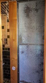 Bath Room, Stone Tile Wall, Stone Counter, Slate Floor, Enclosed Shower, Open Shower, Concrete Floor, Glass Tile Wall, and Ceramic Tile Wall Handmade Door to Upstairs Bathroom  Photo 17 of 34 in The Palimpsest House by Tara Lord