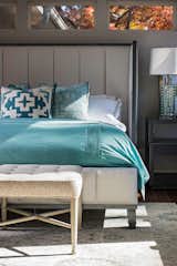 A guest bedroom offers a welcoming respite with open expanses of window glass and sea glass color combinations.  Furnishings in the bedrooms include such manufacturers as Baker, Mr. Brown, Julian Chichester, French Heritage, Dalense, Vanguard, Thayer Coggin and Huppe. 