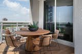 A contemporary wooden dinette adds seating for gathering, entertaining or taking in the southern Florida view.