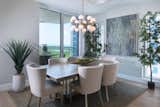 Modern lighting offers a shining accent to the next dinner party for six.  This gathering space including furnishings by Hickory White and Swaim is highlighted by views of nature as well as original artwork by Charles Harold.  