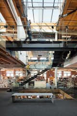 Renowned architecture firm Olson Kundig occupies three floors of a 19th-century loft building in Seattle’s historic Pioneer Square neighborhood. A crucial concern was opening the office up to more natural light; a staircase that cuts through the office’s three levels was added underneath the central skylight, which opens via a hydraulic lift system.