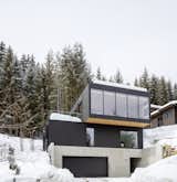 The Gilbert House is clad in matte black wood and concrete, and situated on a steep site.  Photo 2 of 143 in GOAL - Home by David Brandt from This Minimalist Ski Cabin in Whistler Shines in Every Season